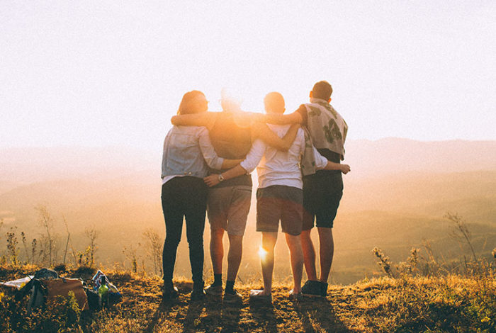 Group of friends embracing at sunset, symbolizing the aftercare and grief support provided by East Lawn in Sacramento. This image represents the helpful guidance and emotional support available for those touched by grief.