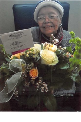 Photo of Higinia Edul and a floral arrangement
