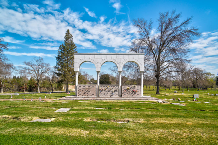 Lush green cemetery with carefully maintained burial plots at East Lawn Greenback & I80.
